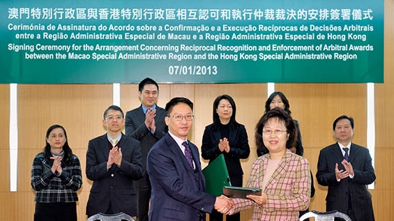 The Secretary for Justice, Mr Rimsky Yuen, SC (fourth left), with the then Secretary for Administration and Justice of the Macao Special Administrative Region, Ms Florinda Chan, after the signing of the Arrangement Concerning Reciprocal Recognition and Enforcement of Arbitral Awards Between the Hong Kong Special Administrative Region and the Macao Special Administrative Region in January 2013