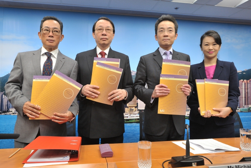 The chairman of the Law Reform Commission (LRC)'s Adverse Possession Sub-committee, Mr Edward Chan, SC (second left); Sub-committee member Mr Michael Yin (second right); the Secretary of the LRC, Mr Stephen Wong (first left); and the secretary of the Sub-committee, Ms Cathy Wan (first right), present a consultation paper on adverse possession at a press conference today (December 10).