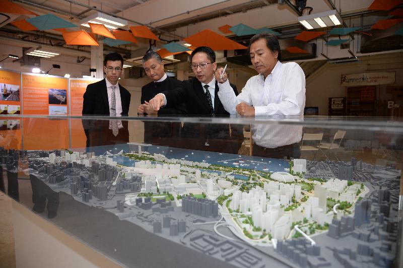 Mr Yuen (second right) is briefed by the Head of the Energizing Kowloon East Office, Mr Raymond Lee (first right), on the Energizing Kowloon East project.