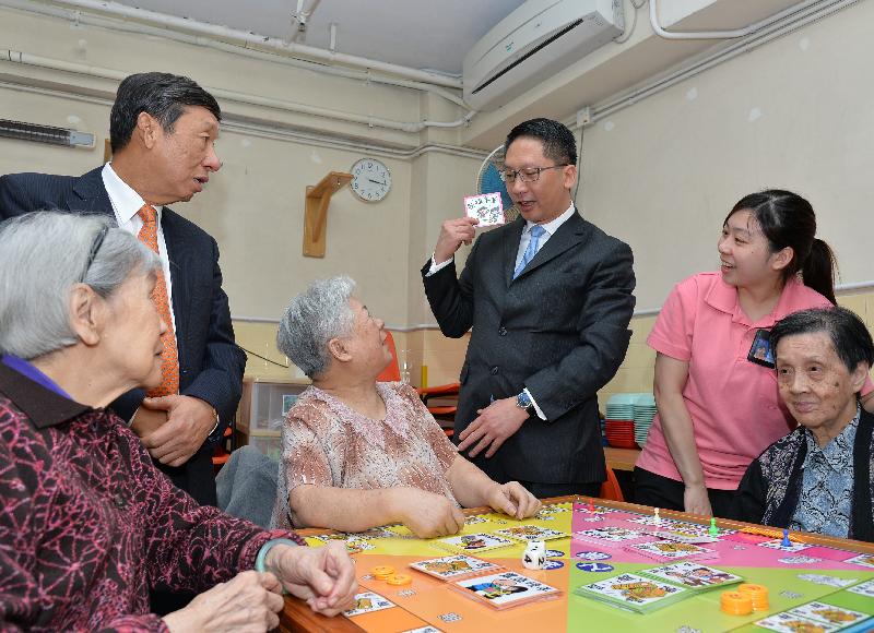 Mr Yuen (third right) chats with the elderly residents.