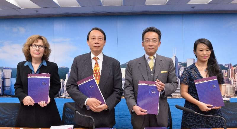 The Chairman of the Law Reform Commission (LRC)'s Adverse Possession Sub-committee, Mr Edward Chan, SC (second left); Sub-committee member Mr Michael Yin (second right); the Acting Secretary of the LRC, Ms Michelle Ainsworth (left); and the Secretary of the Sub-committee, Ms Cathy Wan (right), with copies of the report on adverse possession at today's (October 20) press conference.