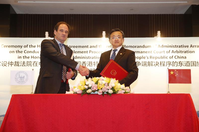 外交部副部长刘振民（右）代表中央人民政府与雨果?汉斯?斯布勒斯（左）签署东道国协议。