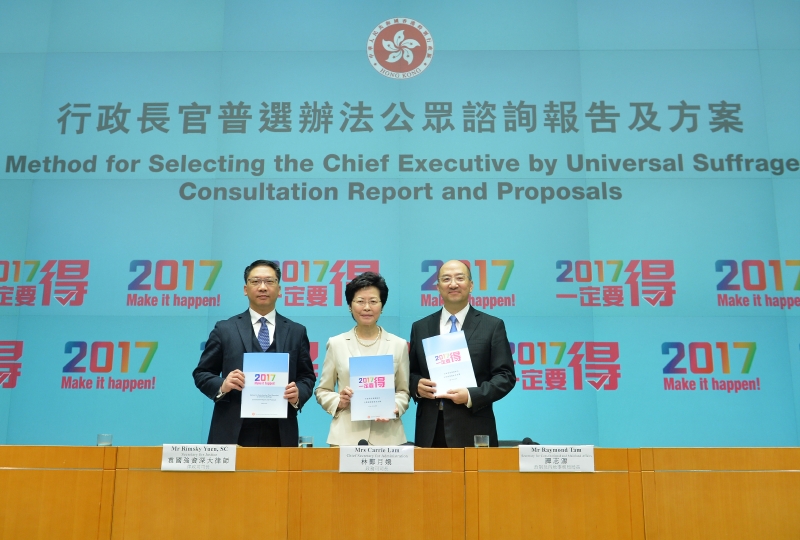The Chief Secretary for Administration, Mrs Carrie Lam (centre); the Secretary for Justice, Mr Rimsky Yuen, SC (left); and the Secretary for Constitutional and Mainland Affairs, Mr Raymond Tam (right), hold a press conference on the Consultation Report and Proposals on the Method for Selecting the Chief Executive by Universal Suffrage at the Central Government Offices at April 22 afternoon.
