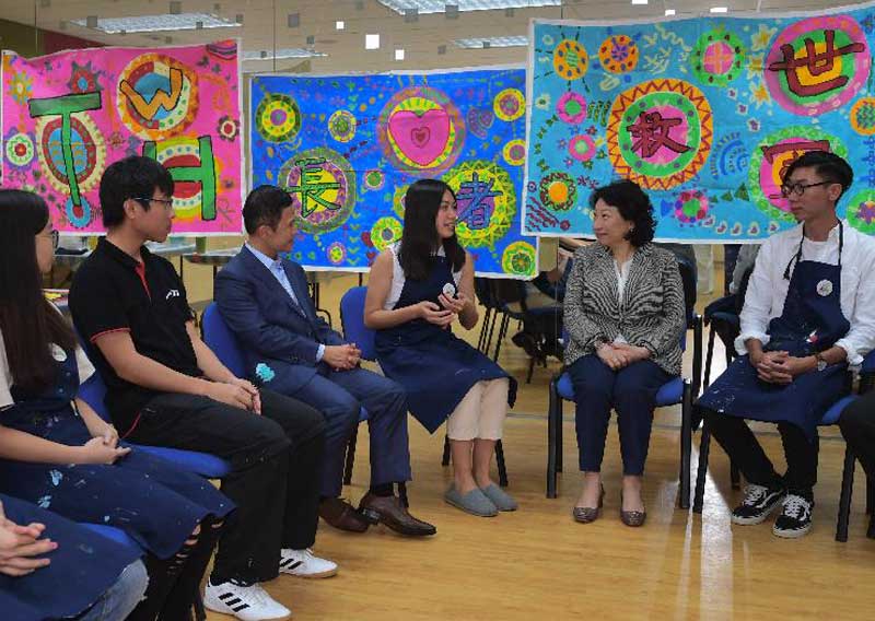 The Secretary for Justice, Ms Teresa Cheng, SC (second right), visits the Salvation Army Tai Wo Hau Children and Youth Centre in Kwai Tsing District today (August 15). Photo shows Ms Cheng chatting with young volunteers in the centre.