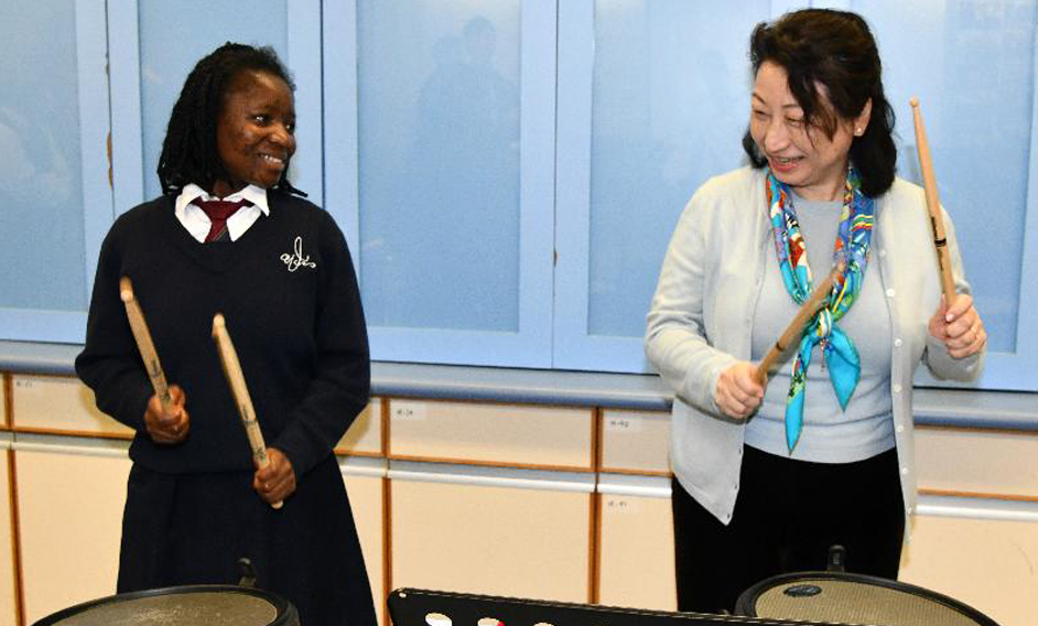 The Secretary for Justice, Ms Teresa Cheng, SC, visits Caritas Wu Cheng-chung Secondary School in Pokfulam today (March 12). Photo shows Ms Cheng (right) joining a student in music class.