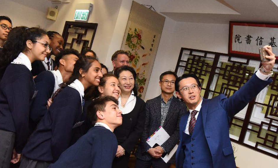 The Secretary for Justice, Ms Teresa Cheng, SC, visited YMCA of Hong Kong Christian College in Tung Chung today (April 1). Photo shows Ms Cheng (third right) with the District Officer (Islands), Anthony Li (second right), as well as teachers and students.